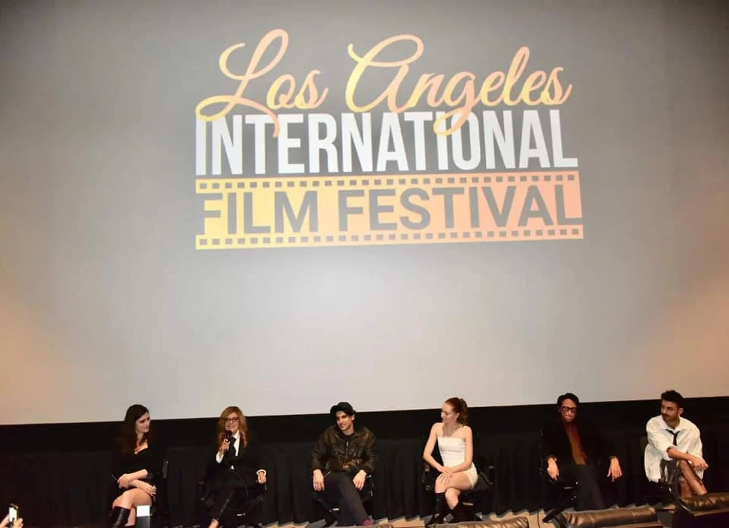 Filmmakers taking part in a panel beneath the LAIFF screen